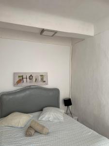 a bed with a towel laying on top of it at Studio Calendal in Cassis