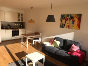 a living room with a couch and a table at Central Garden-Mountain Apartment in Garmisch-Partenkirchen