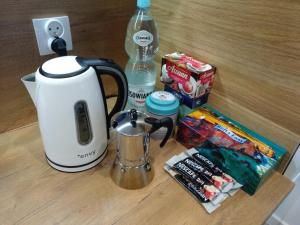a counter with a coffee maker and a blender and snacks at Apartament Poniatowskiego in Radom