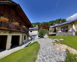 a stone path in front of a house at Village Paradis in Roisan