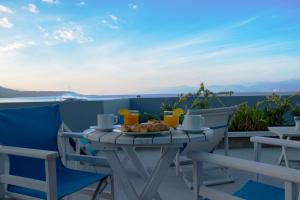 a table with a plate of food on a balcony at Derveni Luxury Apartments in Derveni