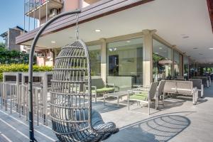 a bird cage hanging from a pole in front of a building at Hotel Riz in Cervia