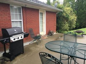 a patio with a grill and a table and chairs at CountryMusic B&B Studios in Camden +5 photos