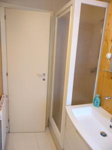 a bathroom with a shower and a white sink at Chalet Fiocco di neve, Passo del Tonale in Passo del Tonale