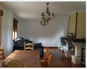 sala de estar con mesa de comedor y lámpara de araña. en Casa independiente, en Liendo