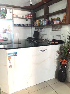 a kitchen with a counter in a restaurant at Hotel Fortaleza III Manaus in Manaus