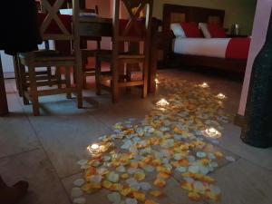 a pile of candy on the floor in a room with chairs and candles at Apartamentos Fuentevieja in Arbancón