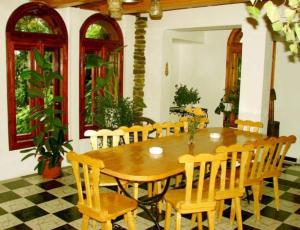 a wooden table and chairs in a room at Pension Casa Aurora in Vama