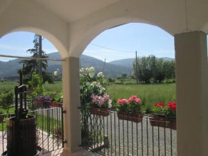 a porch with flowers and a fence at Casa Margubbio in Ameglia
