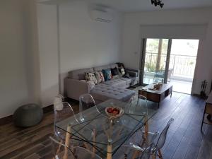 a living room with a couch and a glass table at Evmelia Kakopetria Suites in Kakopetria