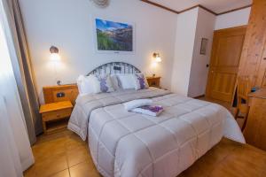Postel nebo postele na pokoji v ubytování Hotel Iris