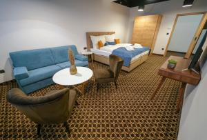 a hotel room with a bed and a couch at 1st World NFT Block & Art Capsule Hostel MetaCHORS in Bratislava