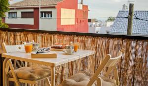 マラガにあるApartamento Los tres solesのテーブルと椅子、バルコニー(食べ物と飲み物付)