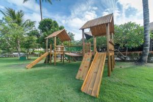a wooden playground with a slide and a gazebo at Condomínio Nannai Residence - Anchova 01 in Porto De Galinhas