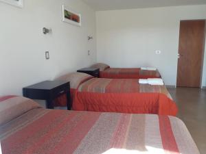 Una cama o camas en una habitación de Hotel Parador Ruta 40