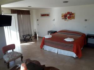 Una cama o camas en una habitación de Hotel Parador Ruta 40