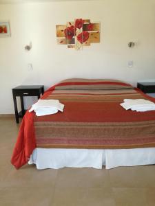 Una cama o camas en una habitación de Hotel Parador Ruta 40