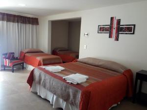 Una cama o camas en una habitación de Hotel Parador Ruta 40
