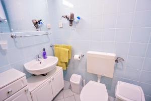 a bathroom with a white toilet and a sink at Apartment Vlado in Zambratija