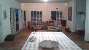 a living room with a table and chairs at Cabaña Playa De Los Venados in San Bernardo del Viento