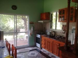 a kitchen with an open door to a deck at Sueños del Este in Costa del Este +20 photos