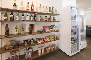 a refrigerator filled with lots of bottles of alcohol at Pensione UNO in Niseko