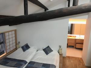 Postel nebo postele na pokoji v ubytování Auberge AZABU