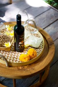 a table with a bottle of wine and a plate of food at Kalapa Boutique Resort & Yoga in Canggu