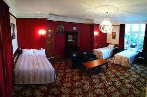 a hotel room with two beds and a table at Motel Mayfair on Cavell in Hobart
