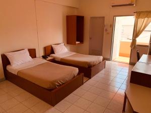 Postel nebo postele na pokoji v ubytování Baansilp Hotel