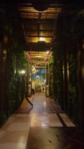 a hallway with plants in a building at night at Lohas Villa in Naha