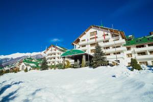 a large building with a ski lift on top of it at Grand Hotel Polyana in Estosadok