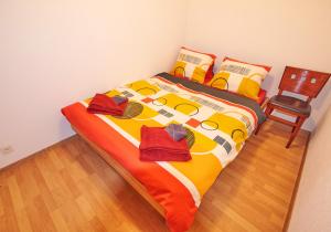 a bedroom with a bed with a chair and red shoes at Golden River in Unterseen