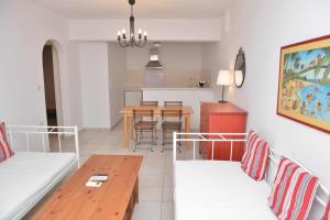 a living room with a couch and a table at Paradisia Villas in Naxos Chora