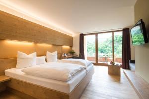 a bedroom with a large bed and a large window at Hotel-Restaurant Ruland in Altenahr