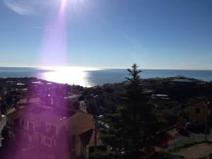 a view of the ocean with the sun in the sky at Agriturismo Il Vecchio Mulino in Terzorio