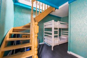 a bunk room with a staircase and bunk beds at Huyze Aïda in Bruges