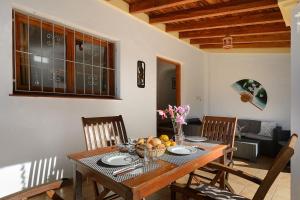 a dining room table with a bowl of fruit on it at Villa Can Turrent in Sant Carles de Peralta
