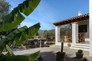 a house with a patio with a cactus at Villa Can Turrent in Sant Carles de Peralta