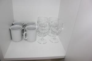 a group of wine glasses sitting on a shelf at Rachel's Apartments in Paramaribo
