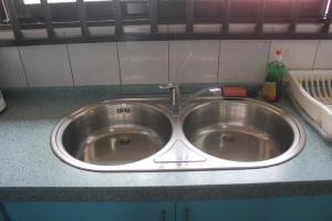 a kitchen sink with a faucet on a counter at Rachel's Apartments in Paramaribo +20 photos