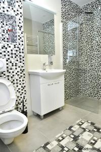 a bathroom with a toilet and a sink and a shower at Vajda Apartments in Novi Sad +32 photos