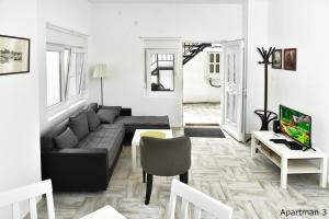 a living room with a couch and a tv at Vajda Apartments in Novi Sad