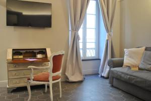a living room with a chair and a dresser at Locanda San Tomaso Affittacamere in Pietra Ligure