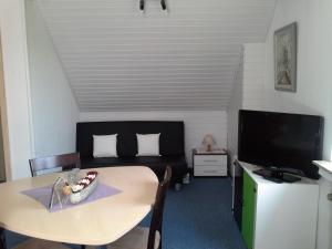 a living room with a table and a couch at Haus Mariandl in Düsseldorf