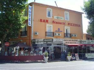 a building on a street with a bar restaurant at L'Avenue in Agde
