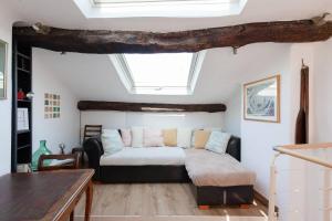 a bedroom with a bed and a skylight at Fisherman’s House in Cannes