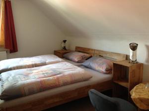 a bedroom with two twin beds and a table at CasaNova in Bad Windsheim