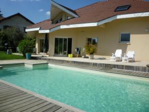 a swimming pool in front of a house at Chez Brigitte et Sylvain in Annecy