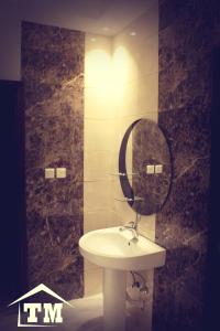 a bathroom with a sink and a mirror at شقق الزوايا الهادئه للشقق المخدومة - اقتصادي - Alzwaya Alahadea Apartments in Jeddah